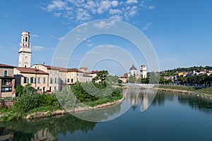 view looking up the Fiume Adige towards the St Giorgio church in Verona Italy