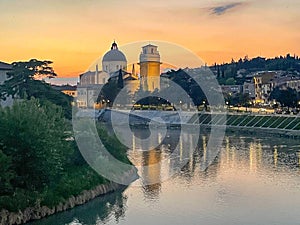 view looking up the Fiume Adige towards the St Giorgio church in Verona Italy at twilight