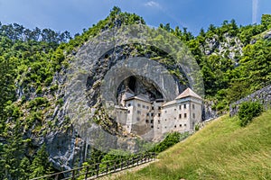A view looking up at the medieval castle built into the cliff face at Predjama, Slovenia