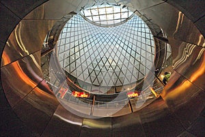 View looking up into patterned architecture at shopping mall area inside Fulton Street MTA train station.