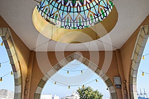 Beautiful dome and arch with lanterns hanging on it. photo