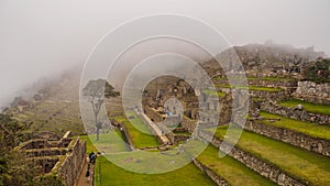 View of the Lost Incan City of Machu Picchu inside de fog, near Cusco, Peru