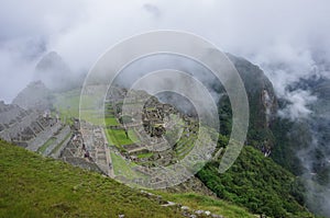 View of the Lost Incan City of Machu Picchu near Cusco.Low cloud