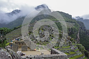 View of the Lost Incan City of Machu Picchu near Cusco. Low clouds cover mountains. Cusco Region, Sacred Valley, Peru