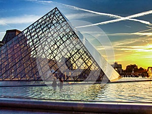 Louvre and Glass piramid during sunset. Paris France.