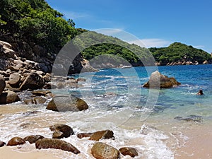 View of Lovers` Beach, sand rocks and waves on Roqueta Island photo