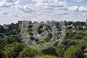 View of low-rise buildings and private houses surrounded by many trees