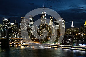 View of lower Manhattan and Financial district at night. Skyscrapers with lights on in New York City