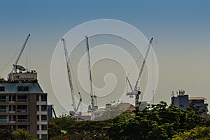 View of luffing jib tower crane at condominium construction site