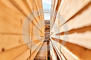 View of a lumber yard between stacks of boards