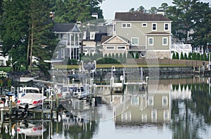 The view of the luxury waterfront homes with boat lifts by the bay near Rehoboth Beach, Delaware, U.S