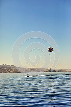 The view from the luxury yacht to the open red sea with the attraction flying on a parachute tied to a boat