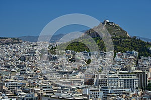 A view of Lykavittos Hill from the Areopagus Hill in Athens, Greece