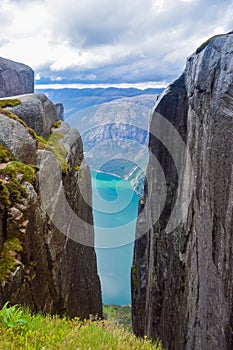 View of Lysefjorden through a crevice between two cliffs 984 meters high, where the famous Kjeragbolten stuck nearby. Norway