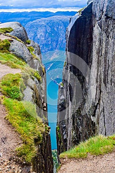 View of Lysefjorden through a crevice between two cliffs 984 meters high, where the famous Kjeragbolten stuck nearby. Norway