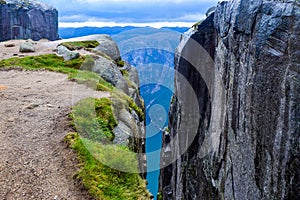 View of Lysefjorden through a crevice between two cliffs 984 meters high, where the famous Kjeragbolten stuck nearby. Norway