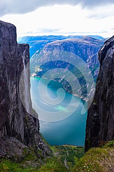 View of Lysefjorden through a crevice between two cliffs 984 meters high, where the famous Kjeragbolten stuck nearby. Norway