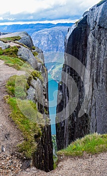 View of Lysefjorden through a crevice between two cliffs 984 meters high, where the famous Kjeragbolten stuck nearby. Norway