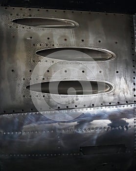 VIEW OF MACHINE GUN PORTS ON THE SIDE OF A METAL FINNISH SABRE JET