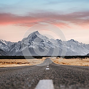 View of the majestic Aoraki Mount Cook with the road leading to Mount Cook Village. Taken during winter in New Zealand.