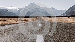 View of the majestic Aoraki Mount Cook with the road leading to Mount Cook Village. Taken during winter in New Zealand.