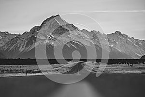 View of the majestic Aoraki Mount Cook with the road leading to Mount Cook Village. Taken during winter in New Zealand.