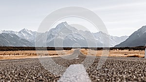 View of the majestic Aoraki Mount Cook with the road leading to Mount Cook Village. Taken during winter in New Zealand.