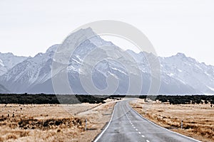 View of the majestic Aoraki Mount Cook with the road leading to Mount Cook Village. Taken during winter in New Zealand.