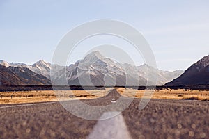 View of the majestic Aoraki Mount Cook with the road leading to Mount Cook Village. Taken during winter in New Zealand.