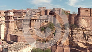 view of the majestic Mehrangarh Fort\'s facades and exterior walls surrounded by birds of prey in Jodhpur, Rajasthan, India