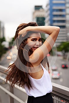 This view is making me feel so alive. Cropped portrait of an attractive young woman smiling while standing on a balcony
