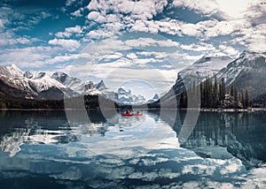 View of Maligne Lake with tourist canoeing into Spirit Island at Jasper national park, Canada
