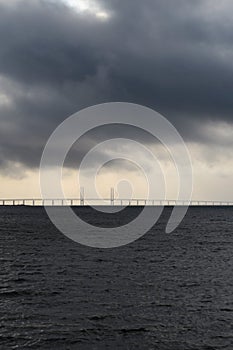 View from Malmo in Sweden on the Oresund bridge with dark clouds