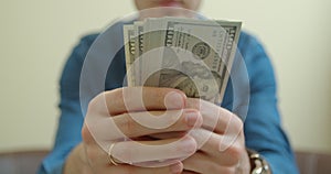 View of a man Counting Many American 100 bills, Man not happy about not having enough money. Slowmotion.