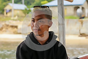 view of a man enjoying on the sailing traditional boat heading to Rangko Cave West Manggarai East Nusa Tenggara photo