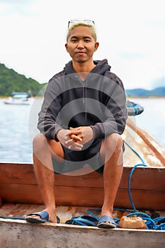 view of a man enjoying on the sailing traditional boat heading to Rangko Cave West Manggarai East Nusa Tenggara photo