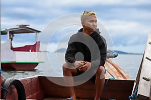 view of a man enjoying on the sailing traditional boat heading to Rangko Cave West Manggarai East Nusa Tenggara photo