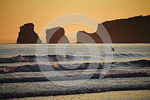 View on man going diving to atlantic ocean in sunrise