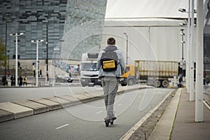 view of a man moving with an electric scooter in Paris