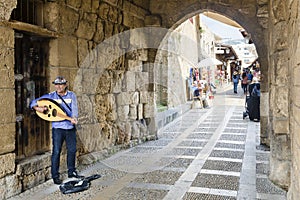 Man playing Oud at the entrance of Byblos souk market, Jbeil, Lebanon