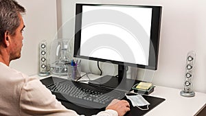 View of man using computer monitor with mockup image blank screen with white background for advertising text