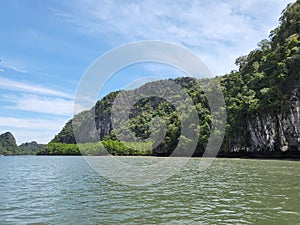 View of mangrove forest and limestone hills from boat cruise in Kilim Karst Geoforest Park, Langkawi, Kedah, Malaysia.