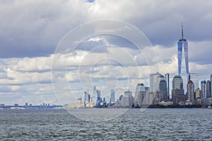 View of Manhattan skyscrapers on both sides of Hudson river under blue sky with white clouds. New York,