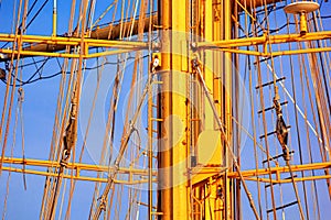 View of the masts and rigging of a sailing ship close-up against the background of sky