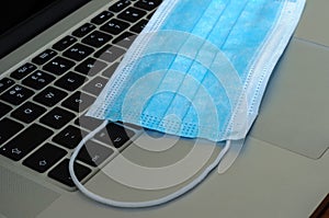 View on a medical mask on an open laptop pc