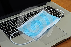 View on a medical mask on an open laptop pc