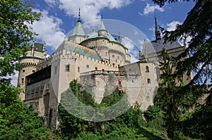 View on medieval Bojnice castle with gothic tower and colorful r