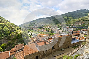 View of the Medieval Church of Saint Anthony clock tower and city and valley of Dolceacqua, Italy, from the ancient hilltop castle