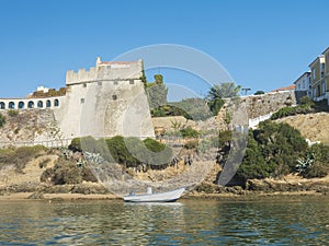 View of medieval fort Forte de Sao Clemente over the Mira river with small boat in sunny day with clear blue sky. Vila