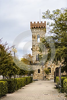 View of the medieval fortress tower from the alley in the city park in Greve In Chianti, Tuscany, Italy
